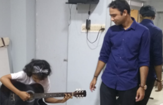 Student practicing guitar at Caprice Music Academy