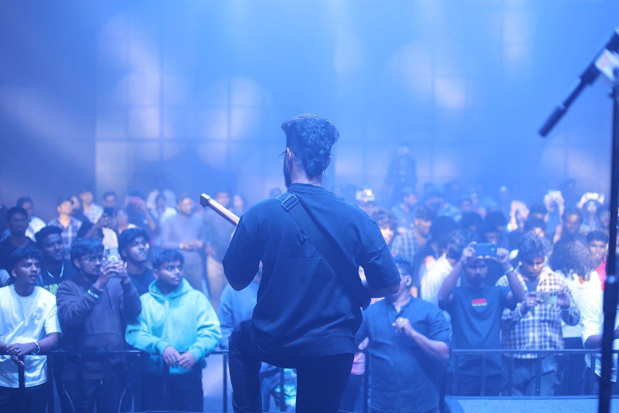 Ezekiel Bernard facing the crowd from the stage