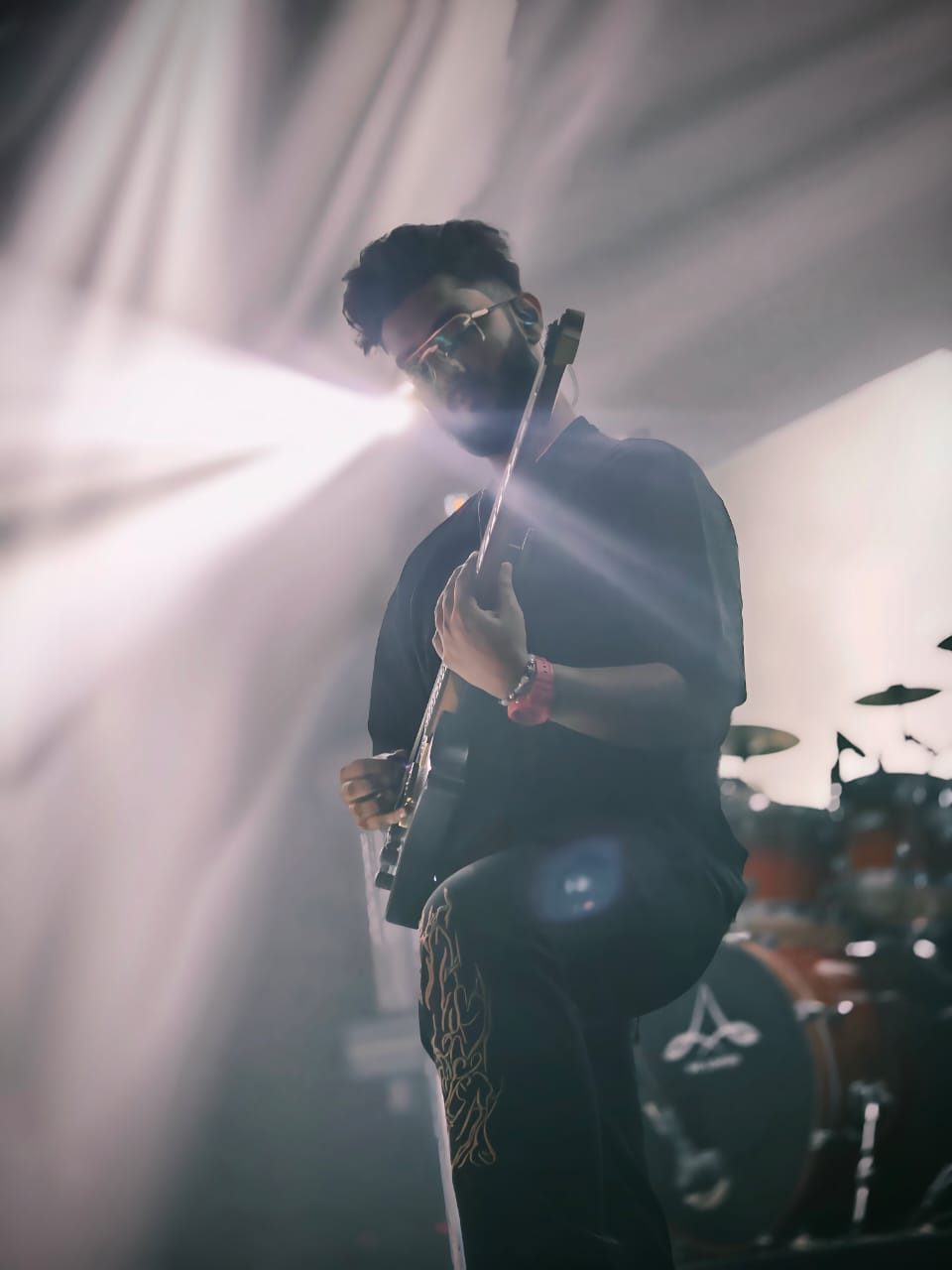 Ezekiel Bernard backlit on stage