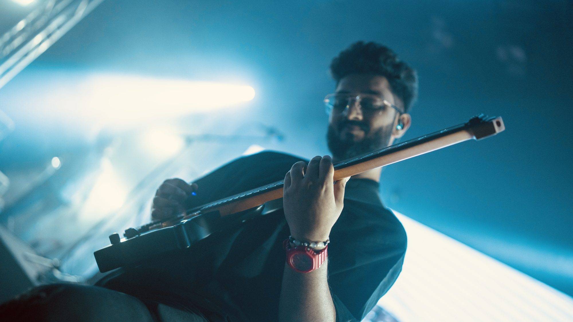 Close-up of Ezekiel Bernard playing in blue light