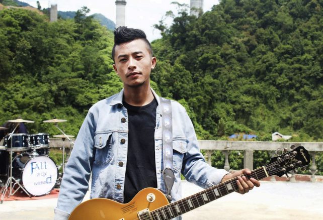Kabung Gondaimei holding a Les Paul outdoors