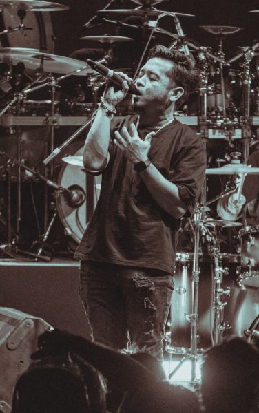 Vocalist singing with The Levites