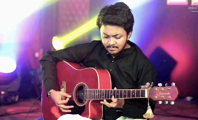 Abhishekh Prabhu performing with acoustic guitar