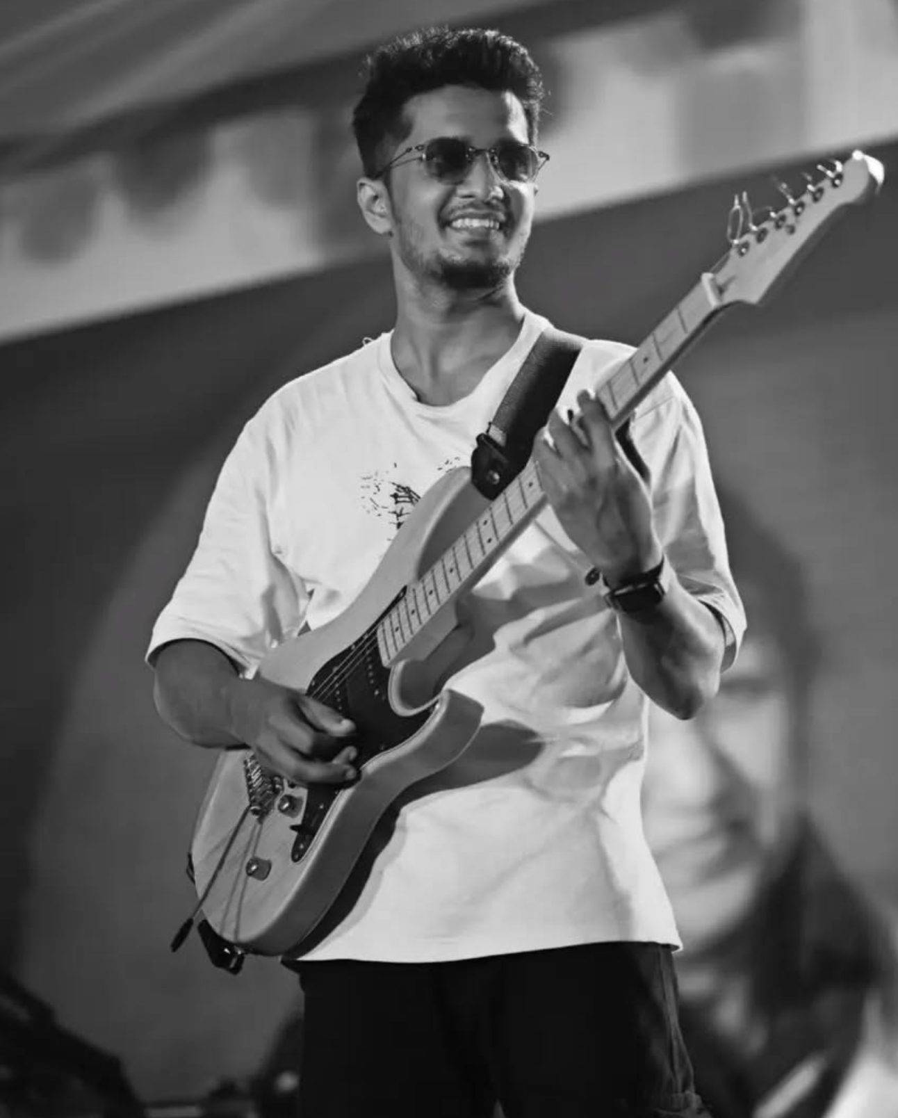 Vamsi Nath on stage in black and white