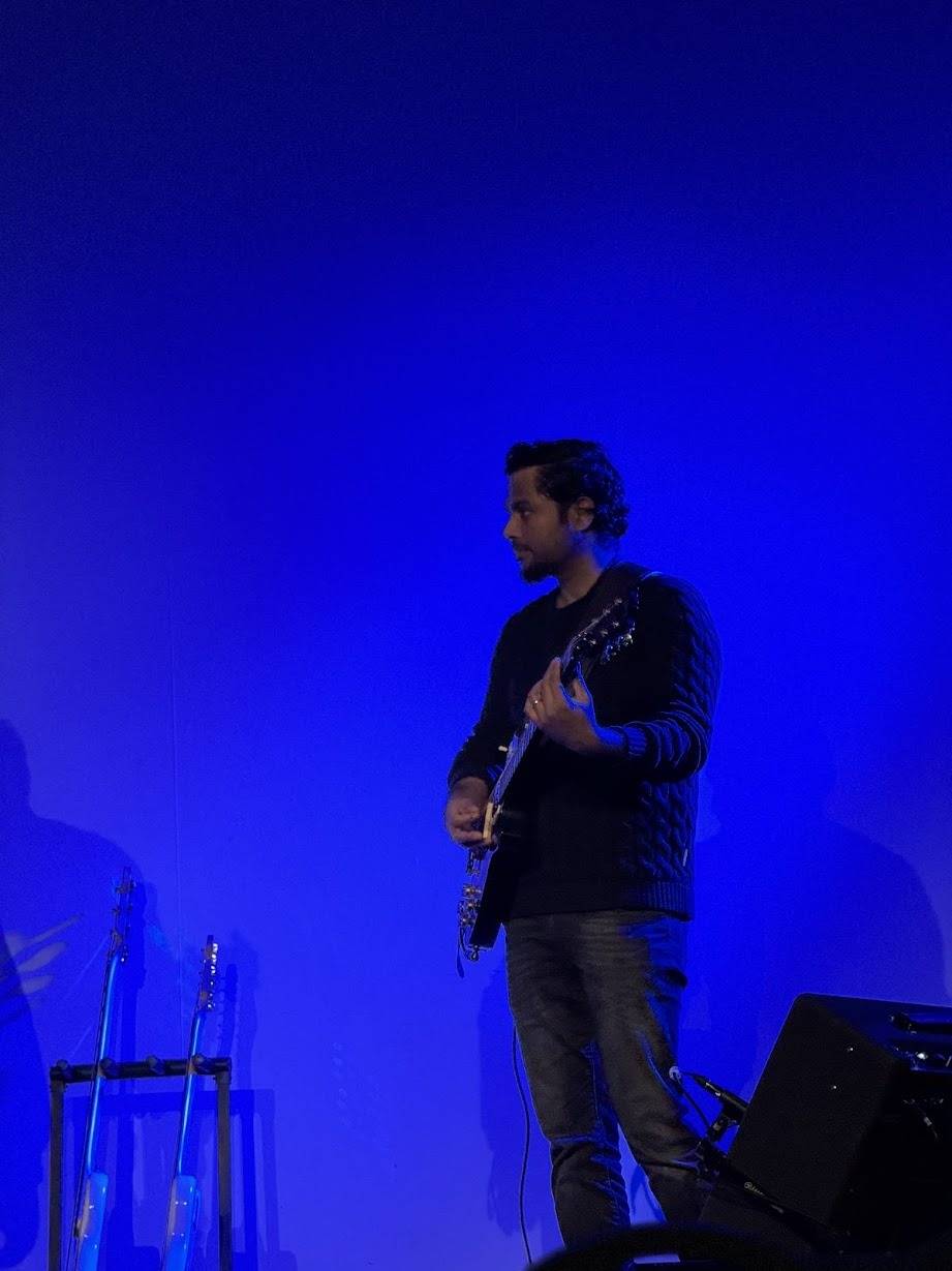 Stephen G Emmanuel on stage under blue lights