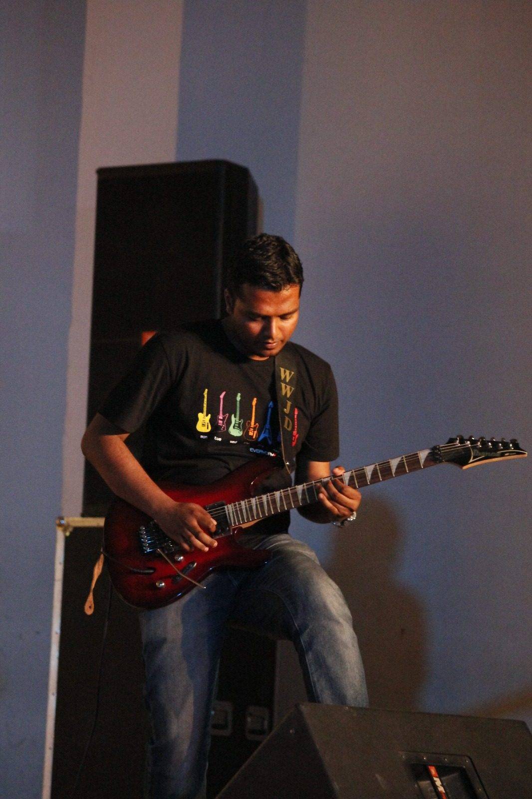 Stephen G Emmanuel seated on stage