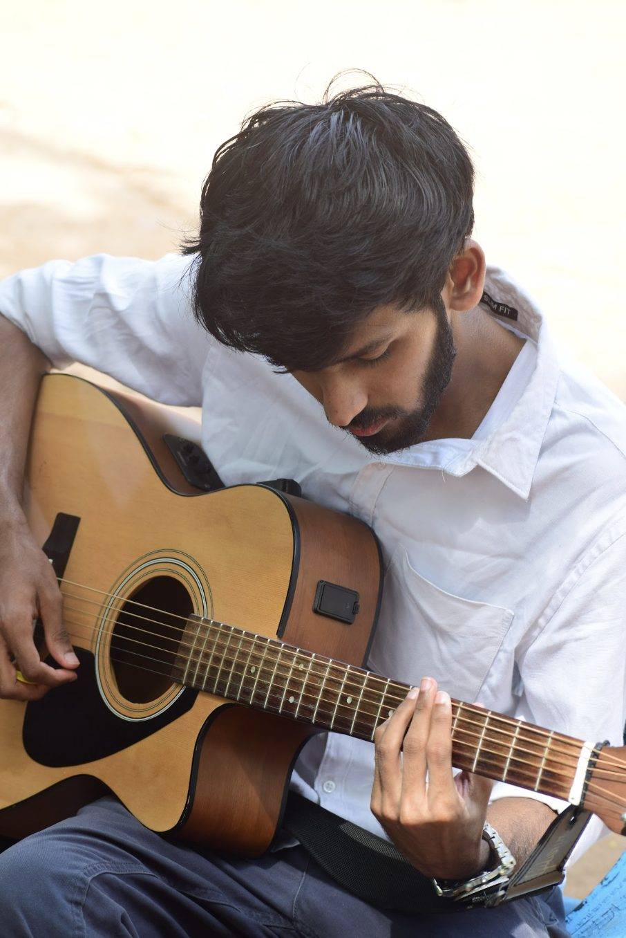 Sreeram Vijay playing acoustic guitar outdoors